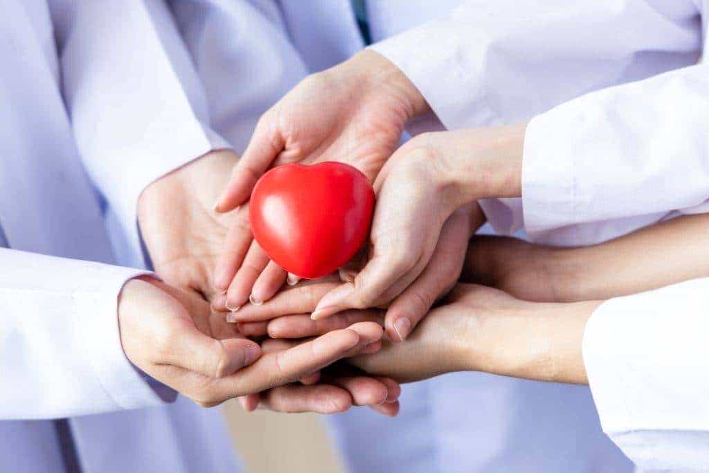 group of hands holding a red heart hand of doctor 2023 11 27 04 55 12 utc